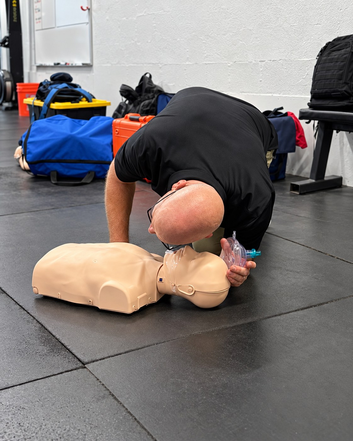 Instructor demonstrating airway and ventilation technique on a CPR training manikin.